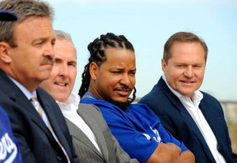 GLENDALE, AZ - MARCH 05:  Manny Ramirez#99 (2R) general manager Ned Colletti (L) owner Frank McCourt and Ramirez's agent Scott Booras  (R) look on during a news conference on March 5, 2009, at Camelback Ranch in Glendale, Arizona. Ramirez signed a $45 million two-year contract on Wednesday.  (Photo by Kevork Djansezian/Getty Images)