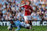 MANCHESTER, ENGLAND - SEPTEMBER 12:  Gael Clichy (R) of Arsenal is tackled by Joleon Lescott during the Barclays Premier League match between Manchester City and Arsenal at the City of Manchester Stadium on September 12, 2009 in Manchester, England.  (Photo by Shaun Botterill/Getty Images)
