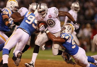OAKLAND, CA - SEPTEMBER 14:  Darren McFadden #20 of the Oakland Raiders runs the ball against Stephen Cooper #54 of the San Diego Chargers on September 14, 2009 at the Oakland-Alameda County Coliseum in Oakland, California.  (Photo by Ezra Shaw/Getty Images)