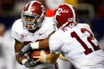 ATLANTA - SEPTEMBER 05:  Running back Mark Ingram #22 of the Alabama Crimson Tide takes a handoff from quarterback Greg McElroy #12 against the Virginia Tech Hokies during the Chick-fil-A Kickoff Game at Georgia Dome on September 5, 2009 in Atlanta, Georgia.  (Photo by Kevin C. Cox/Getty Images)