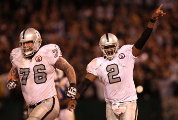 OAKLAND, CA - SEPTEMBER 14:  (L-R) Robert Gallery #76 and JaMarcus Russell #2 of the Oakland Raiders celebrate after Russell threw a 57-yard touchdown pass to Louis Murphy #18 in the fourth quarter against the San Diego Chargers on September 14, 2009 at the Oakland-Alameda County Coliseum in Oakland, California.  (Photo by Ezra Shaw/Getty Images)