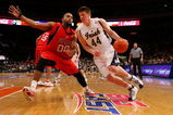 NEW YORK - MARCH 10:  Gregory Echenique #00 of the Rutgers Scarlet Knights defends against Luke Harangody #44 of the Notre Dame Fighting Irish during the first round of the Big East Tournament at Madison Square Garden on March 10, 2009 in New York City.  (Photo by Jim McIsaac/Getty Images)