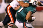 CANTON, OH - AUGUST 8:  Linebacker Brian Urlacher #54 of the Chicago Bears sacks quarterback A.J. Feeley #7 of the Miami Dolphins during the NFL Hall of Fame pre-season game on August 8, 2005 in Canton, Ohio.  (Photo by Jonathan Daniel/Getty Images)
