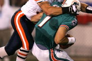 CANTON, OH - AUGUST 8: Linebacker Brian Urlacher #54 of the Chicago Bears sacks quarterback A.J. Feeley #7 of the Miami Dolphins during the NFL Hall of Fame pre-season game on August 8, 2005 in Canton, Ohio. (Photo by Jonathan Daniel/Getty Images)