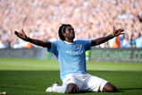 MANCHESTER, ENGLAND - SEPTEMBER 12:  Emmanuel Adebayor of Manchester City celebrates in front of the Arsenal fans after scoring during the Barclays Premier League match between Manchester City and Arsenal at the City of Manchester Stadium on September 12, 2009 in Manchester, England.  (Photo by Shaun Botterill/Getty Images)