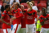 WIGAN, ENGLAND - AUGUST 22:  Dimitar Berbatov of Manchester United celebrates with his team mates after scoring the second goal during the Barclays Premier League match between Wigan Athletic and Manchester United at the DW Stadium on August 22, 2009 in Wigan, England.  (Photo by Alex Livesey/Getty Images)