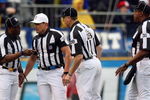 SAN DIEGO - JANUARY 06:  Head Referee Ed Hochuli, wearing the white hat, confers with his colleagues after a play in the first quarter as quarterback Vince Young #10 of the Tennessee Titans rolls on the ground after a defensive play by the San Diego Chargers in the first quarter during their AFC Wild Card Playoff Game at Qualcomm Stadium on January 6, 2008 in San Diego, California.  The Chargers defeated the Titans 17-6. (Photo by Donald Miralle/Getty Images)