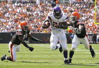 CLEVELAND - SEPTEMBER 13:  Adrian Peterson #28 of the Minnesota Vikings runs by Brodney Pool #21 and Corey Willams #99 of the Cleveland Brwons at Cleveland Browns Stadium on September 13, 2009 in Cleveland, Ohio.  (Photo by Matt Sullivan/Getty Images)