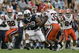 STATE COLLEGE, PA - SEPTEMBER 12: Tail back Evan Royster #22 of the Penn State Nittany Lions rushes through linebacker Doug Hogue #32 and safety Mike Holmes #35 of the Syracuse Orangemen during the first half at Beaver Stadium  September 12, 2009 in State College, Pennsylvania. (Photo by Chris Gardner/Getty Images)