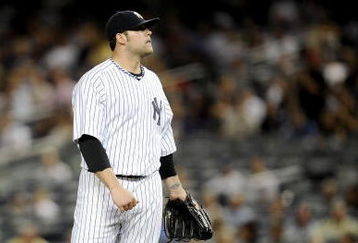NEW YORK - SEPTEMBER 14:  Joba Chamberlain #62 of the New York Yankees stands on the mound as Vladimir Guerrero #27 of the Los Angeles Angels of Anaheim rounds the bases on his solo home run in the second inning of a game at Yankee Stadium on September 14, 2009 in the Bronx borough of New York City.  (Photo by Jeff Zelevansky/Getty Images)