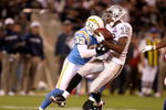 OAKLAND, CA - SEPTEMBER 14:  Johnnie Lee Higgins #15 of the Oakland Raiders is hit by Eric Weddle #32 of the San Diego Chargers during their game on September 14, 2009 at the Oakland-Alameda County Coliseum in Oakland, California.  (Photo by Ezra Shaw/Getty Images)