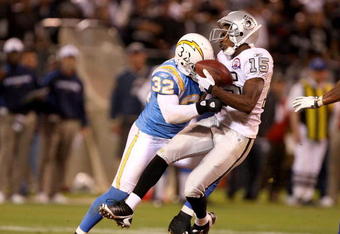 OAKLAND, CA - SEPTEMBER 14:  Johnnie Lee Higgins #15 of the Oakland Raiders is hit by Eric Weddle #32 of the San Diego Chargers during their game on September 14, 2009 at the Oakland-Alameda County Coliseum in Oakland, California.  (Photo by Ezra Shaw/Getty Images)