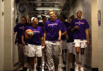 PHOENIX - AUGUST 21:  Temeka Johnson #2 and Kelly Mazzante #33 of the Phoenix Mercury lead teammates out onto the court before the WNBA game against the Washington Mystics at US Airways Center on August 21, 2009 in Phoenix, Arizona. NOTE TO USER: User expressly acknowledges and agrees that, by downloading and or using this photograph, User is consenting to the terms and conditions of the Getty Images License Agreement.  (Photo by Christian Petersen/Getty Images)