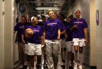 PHOENIX - AUGUST 21:  Temeka Johnson #2 and Kelly Mazzante #33 of the Phoenix Mercury lead teammates out onto the court before the WNBA game against the Washington Mystics at US Airways Center on August 21, 2009 in Phoenix, Arizona. NOTE TO USER: User expressly acknowledges and agrees that, by downloading and or using this photograph, User is consenting to the terms and conditions of the Getty Images License Agreement.  (Photo by Christian Petersen/Getty Images)
