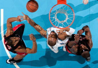 NEW ORLEANS - FEBRUARY 06:  David West #30 of the New Orleans Hornets grabs a rebound over Joey Graham #14 and Jermaine O'Neal #6 of the Toronto Raptors on February 6, 2009 in New Orleans, Louisiana. The Hornets defeated the Raptors 101-92.   NOTE TO USER: User expressly acknowledges and agrees that, by downloading and/or using this Photograph, user is consenting to the terms and conditions of the Getty Images License Agreement.  (Photo by Chris Graythen/Getty Images)