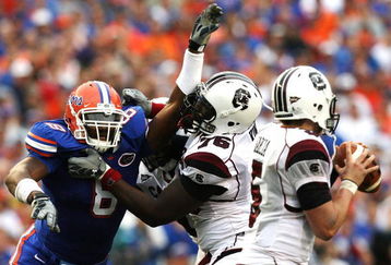 GAINESVILLE, FL - NOVEMBER 15:  Offensive lineman Jarriel King #76 the South Carolina Gamecocks tries to protect his quarterback Stephen Garcia #5 from defensive end Carlos Dunlap #8 of the Florida Gators at Ben Hill Griffin Stadium on November 15, 2008 in Gainesville, Florida.  (Photo by Doug Benc/Getty Images)