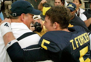 ANN ARBOR, MI - SEPTEMBER 12:  Quarterback Tate Forcier #5 embraces head coach Rich Rodriguez as they approach the tunnel after beating Notre Dame 38-34 at Michigan Stadium on September 12, 2009 in Ann Arbor, Michigan.  (Photo by Domenic Centofanti/Getty Images)