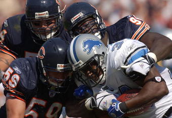 CHICAGO - SEPTEMBER 12: Joe Odom #59, Brian urlacher #54 and Alex brown # 96 of the Chicago Bears combine to tackle Kevin Jones #34 of the Detroit Lions during a game on September 12, 2004 at Soldier Field in Chicago, Illinois. The Lions defeated the Bears 20-16. (Photo by Jonathan Daniel/Getty Images)