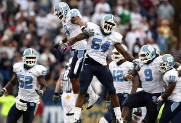EAST HARTFORD, CT - SEPTEMBER 12:  Bruce Carter #54 of the North Carolinia Tar Heels celebrates his sack with teammates Melvin Williams #10, Marvin Austin #9 and Quan Sturdivant #52 in the final minute of the game against the Connecticut Huskies on September 12, 2009 at Rentschler Field in East Hartford, Connecticut. The Tar Heels defeated the Huskies 12-10.  (Photo by Elsa/Getty Images)