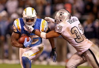 OAKLAND, CA - SEPTEMBER 14:  Antonio Gates #85 of the San Diego Chargers is tackled by Tyvon Branch #33 of the Oakland Raiders during their game on September 14, 2009 at the Oakland-Alameda County Coliseum in Oakland, California.  (Photo by Ezra Shaw/Getty Images)