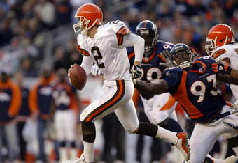 DENVER - DECEMBER 14:  Quarterback Tim Couch #2 of the Cleveland Browns runs out of the pocket on a flea flicker against defensive end Trevor Pryce #93 of the Denver Broncos December 14, 2003 at Invesco Field at Mile High in Denver, Colorado. The Broncos won 23-20 in overtime.  (Photo by Brian Bahr/Getty Images)
