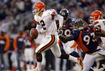 DENVER - DECEMBER 14:  Quarterback Tim Couch #2 of the Cleveland Browns runs out of the pocket on a flea flicker against defensive end Trevor Pryce #93 of the Denver Broncos December 14, 2003 at Invesco Field at Mile High in Denver, Colorado. The Broncos won 23-20 in overtime.  (Photo by Brian Bahr/Getty Images)