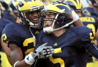 ANN ARBOR, MI - SEPTEMBER 12:  Quarterback Tate Forcier #5 of Michigan gets congratulated by teammate Darryl Stonum #22 after Forcier scored a touchdown late in the fourth quarter against Notre Dame at Michigan Stadium on September 12, 2009 in Ann Arbor, Michigan.  (Photo by Domenic Centofanti/Getty Images)