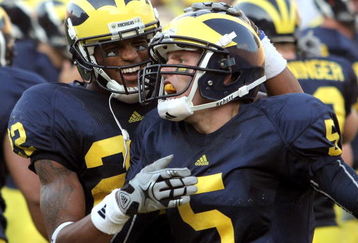 ANN ARBOR, MI - SEPTEMBER 12:  Quarterback Tate Forcier #5 of Michigan gets congratulated by teammate Darryl Stonum #22 after Forcier scored a touchdown late in the fourth quarter against Notre Dame at Michigan Stadium on September 12, 2009 in Ann Arbor, Michigan.  (Photo by Domenic Centofanti/Getty Images)