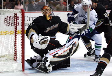 ANAHEIM, CA - MARCH 11:  Goaltender Jonash Hiller #1 of the Anaheim Ducks looks for the puck carrier behind his net as Alex Burrows #14 of the Vancouver Canucks gets into position at the top of the crease area during their NHL game at Honda Center on March 11, 2009 in Anaheim, California. The Ducks defeated the Canucks 4-3 in overtime.  (Photo by Victor Decolongon/Getty Images)