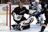 ANAHEIM, CA - MARCH 11:  Goaltender Jonash Hiller #1 of the Anaheim Ducks looks for the puck carrier behind his net as Alex Burrows #14 of the Vancouver Canucks gets into position at the top of the crease area during their NHL game at Honda Center on March 11, 2009 in Anaheim, California. The Ducks defeated the Canucks 4-3 in overtime.  (Photo by Victor Decolongon/Getty Images)