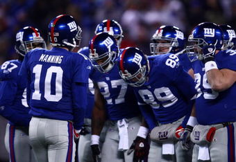 EAST RUTHERFORD, NJ - DECEMBER 21:  Quarterback Eli Manning #10 of the New York Giants talks to his team in a huddle before a play against the Carolina Panthers on December 21, 2008 at Giants Stadium in East Rutherford, New Jersey.  (Photo by Chris McGrath/Getty Images)