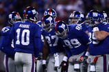 EAST RUTHERFORD, NJ - DECEMBER 21:  Quarterback Eli Manning #10 of the New York Giants talks to his team in a huddle before a play against the Carolina Panthers on December 21, 2008 at Giants Stadium in East Rutherford, New Jersey.  (Photo by Chris McGrath/Getty Images)