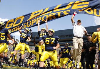 ANN ARBOR, MI - SEPTEMBER 05:  Head coach Rich Rodriguez enters the stadium with his team prior to playing the Western Michigan Broncos on September 5, 2009 at Michigan Stadium in Ann Arbor, Michigan.  (Photo by Gregory Shamus/Getty Images)