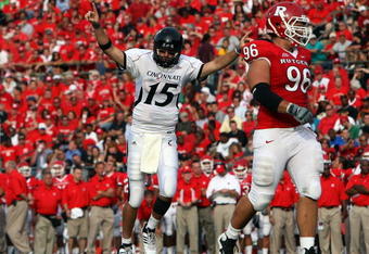 PISCATAWAY, NJ - SEPTEMBER 07:  Tony Pike #15 of the Cincinnati Bearcats celebrates a touchdown as Charlie Noonan #96 of the Rutgers Scarlet Knights looks on at Rutgers Stadium on September 7, 2009 in Piscataway, New Jersey.  (Photo by Jim McIsaac/Getty Images)