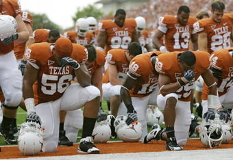 AUSTIN, TX - SEPTEMBER 5:  Members of the Texas Longhorns bow their heads together prior to their game against the Louisiana Monroe Warhawks on September 5, 2009 at Darrell K Royal-Texas Memorial Stadium in Austin, Texas. The Longhorns defeated the Warhawks 59-20. (Photo by Brian Bahr/Getty Images)