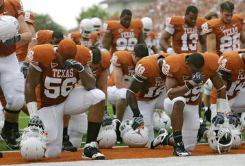 AUSTIN, TX - SEPTEMBER 5:  Members of the Texas Longhorns bow their heads together prior to their game against the Louisiana Monroe Warhawks on September 5, 2009 at Darrell K Royal-Texas Memorial Stadium in Austin, Texas. The Longhorns defeated the Warhawks 59-20. (Photo by Brian Bahr/Getty Images)