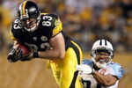 PITTSBURGH - SEPTEMBER 11:  Heath Miller #83 of the Pittsburgh Steelers tries to gain a few more yards as Chris Hope #24 of the Tennessee Titans makes the tackle on September 11, 2009 at Heinz Field in Pittsburgh, Pennsylvania. The Steelers defeated the Titans 13-10 in overtime.  (Photo by Elsa/Getty Images)