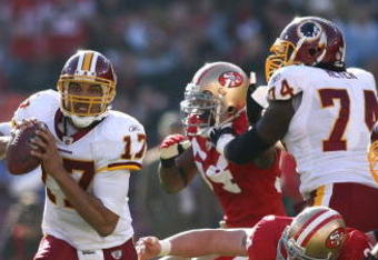 SAN FRANCISCO - DECEMBER 28:  Quarterback Jason Campbell #17 of the Washington Redskins avoids a sack by Justin Smith #94 of the San Francisco 49ers at Candlestick Park on December 28, 2008 in San Francisco, California  (Photo by Jonathan Ferrey/Getty Images)