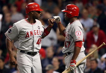 BOSTON - SEPTEMBER 15:  Torii Hunter #468 of the Los Angeles Angels of Anaheim is congratulated by teammate Howie Kendrick #47 after Hunter scored a run in the ninth inning against the Boston Red Sox on September 15, 2009 at Fenway Park in Boston, Massachusetts. The Red Sox defeated the Angels 4-1.  (Photo by Elsa/Getty Images)
