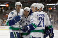 ANAHEIM, CA - SEPTEMBER 17: (L-R) Travis Ramsey #67, Kyle Wellwood #42 and Mason Raymond #21 of the Vancouver Canucks celebrate a goal by Aaron Rome in the second period against the Anaheim Ducks at the Honda Center on September 17, 2009 in Anaheim, California. (Photo by Jeff Gross/Getty Images)
