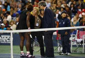 NEW YORK - SEPTEMBER 12:  Serena Williams (L) argues with Brian Early (R) and Donna Kelso (C) after disqualified for a default during the Women's Singles Semifinal match against to Kim Clijsters of Belgium on day thirteen of the 2009 U.S. Open at the USTA Billie Jean King National Tennis Center on September 12, 2009 in the Flushing neighborhood of the Queens borough of New York City.  (Photo by Julian Finney/Getty Images)