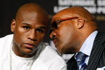 LAS VEGAS - SEPTEMBER 16:  Boxer Floyd Mayweather Jr. (L) and his advisor Leonard Ellerbe confer during the final news conference for Mayweather's bout against Juan Manuel Marquez at the MGM Grand Hotel/Casino September 16, 2009 in Las Vegas, Nevada. Mayweather and Marquez will fight at the MGM Grand Garden Arena on September 19 in Las Vegas.  (Photo by Ethan Miller/Getty Images)
