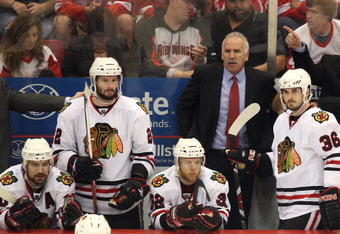 DETROIT - MAY 27:  (L-R) Patrick Sharp #10, Troy Brouwer #22, Kris Versteeg #32, head coach Joel Quenneville and Dave Bolland #36 of the Chicago Blackhawks look on from the bench dejected late in the game against the Detroit Red Wings during Game Five of the Western Conference Championship Round of the 2009 Stanley Cup Playoffs on May 27, 2009 at Joe Louis Arena in Detroit, Michigan.  (Photo by Claus Andersen/Getty Images)