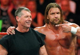 LAS VEGAS - AUGUST 24:  World Wrestling Entertainment Inc. Chairman Vince McMahon (L) and wrestler Triple H appear in the ring during the WWE Monday Night Raw show at the Thomas & Mack Center August 24, 2009 in Las Vegas, Nevada.  (Photo by Ethan Miller/Getty Images)