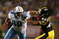 PITTSBURGH - SEPTEMBER 10:  Safety Troy Polamalu #43 of the Pittsburgh Steelers gets a penalty for holding the face mask of tight end Bo Scaife #80 of the Tennessee Titans during the second quarter of the NFL season opener at Heinz Field on September 10, 2009 in Pittsburgh, Pennsylvania. (Photo by Elsa/Getty Images)
