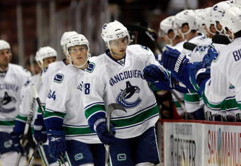 ANAHEIM, CA - SEPTEMBER 17:  Steve Bernier #18 of the Vancouver Canucks receives high fives from the bench after scoring a goal in the first period against the Anaheim Ducks at the Honda Center on September 17, 2009 in Anaheim, California.  (Photo by Jeff Gross/Getty Images)
