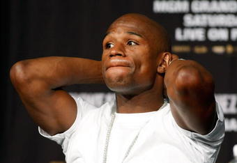 LAS VEGAS - SEPTEMBER 16:  Boxer Floyd Mayweather Jr. stretches during the final news conference for his bout against Juan Manuel Marquez at the MGM Grand Hotel/Casino September 16, 2009 in Las Vegas, Nevada. The two will fight at the MGM Grand Garden Arena on September 19 in Las Vegas.  (Photo by Ethan Miller/Getty Images)