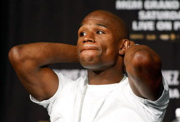 LAS VEGAS - SEPTEMBER 16:  Boxer Floyd Mayweather Jr. stretches during the final news conference for his bout against Juan Manuel Marquez at the MGM Grand Hotel/Casino September 16, 2009 in Las Vegas, Nevada. The two will fight at the MGM Grand Garden Arena on September 19 in Las Vegas.  (Photo by Ethan Miller/Getty Images)