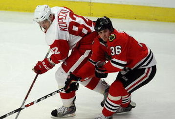 CHICAGO - APRIL 12:  Dave Bolland #36 of the Chicago Blackhawks skates against Tomas Kopecky #82 of the Detroit Red Wings at the United Center on April 12, 2009 in Chicago, Illinois.  (Photo by Jonathan Daniel/Getty Images)