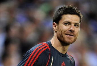 BARCELONA, SPAIN - AUGUST 02:  Xabi Alonso of Liverpool smiles during his warm up reacting to shouts from fans regarding his possible move to Real Madrid during the pre-season friendly match between Espanyol and Liverpool at the Nuevo Estadio de Cornella-El Prat on August 2, 2009 in Barcelona, Spain. Espanyol won the match 3-0.  (Photo by Jasper Juinen/Getty Images)